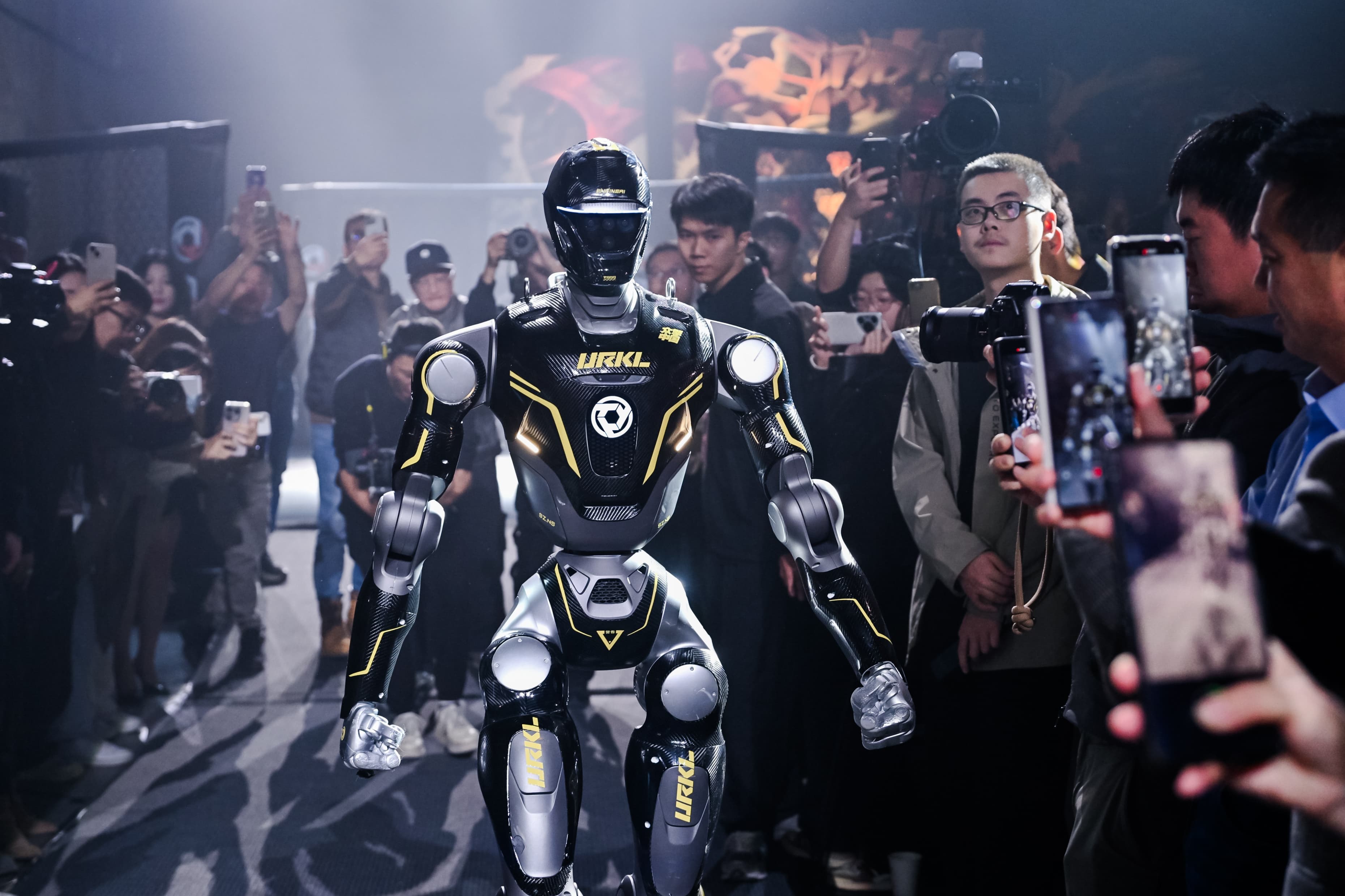 URKL robot entering the arena in front of a crowd of press